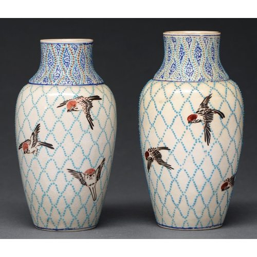 610 - A pair of Japanese satsuma vases, decorated in the manner of contemporary Longwy Pottery, with birds... 