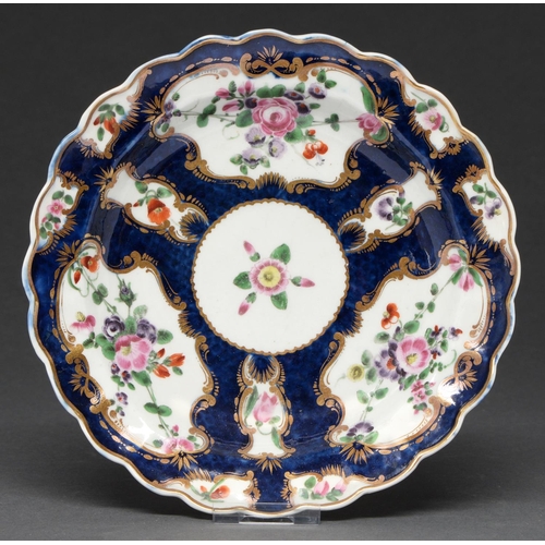 621 - A Worcester scale blue ground plate, c1770, painted with flowers and festoons in gilt reserves, 19cm... 
