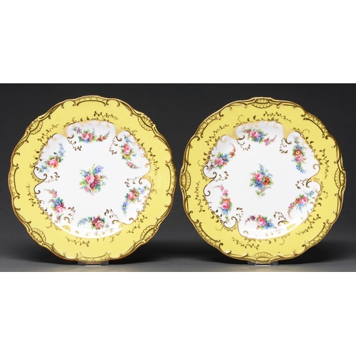 624 - A pair of Mintons yellow ground dessert plates, c1895, painted with scattered flowers in lightly mou... 