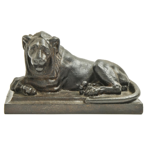 849 - A cast iron sculpture of a recumbent lion, 19th c, on rectangular base, 20cm l