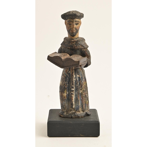 868 - A European polychrome wood statuette of a monk, perhaps Spanish, with open gospel, on black painted ... 