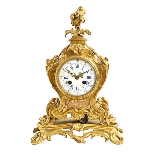 893 - A French ormolu clock, late 19th c, in Louis XV style, the enamel dial with blue numerals, bell stri... 