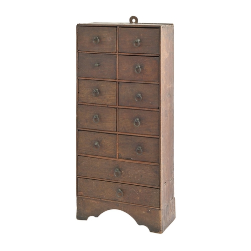 900 - A boarded oak spice chest, of twelve drawers with wire ring pulls, softwood back, 59.5cm h; 12 x 27.... 