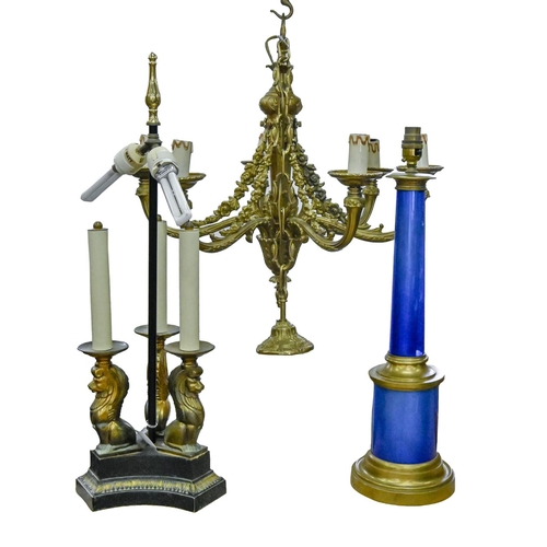 918 - A brass mounted blue foiled glass table lamp, an Empire style bronzed metal three lion lamp and a gi... 