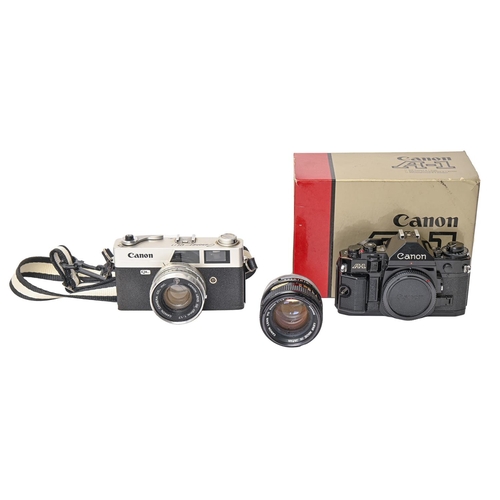 201 - A Canon A1 camera, boxed, with instructions, a Canon 50mm 1:1.4 SSC lens and a Canon Canonet QL17 ca... 