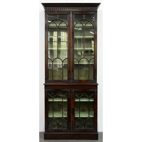 494 - A mahogany bookcase, early 20th c, the upper part with pear drop frieze and enclosed by a pair of do... 