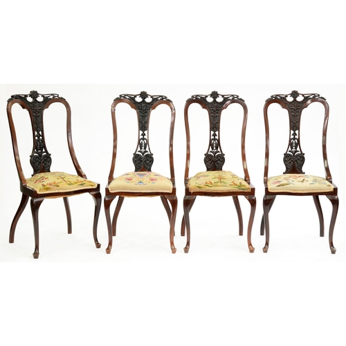 501 - A set of four Edwardian carved mahogany chairs, with padded woolwork seat, cabriole legs... 