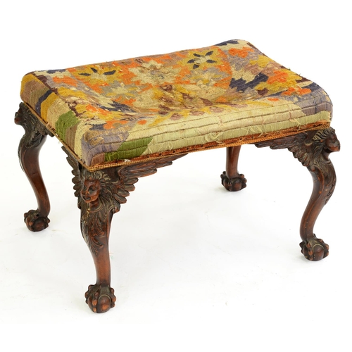 531 - A walnut dressing stool, early 20th c, the cabriole legs carved with head and acanthus, on claw and ... 