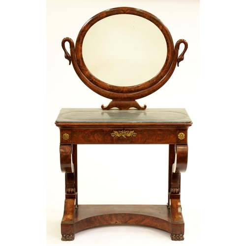 536 - A French Empire mahogany dressing table, in highly figured veneers, the oval mirror supported on a U... 