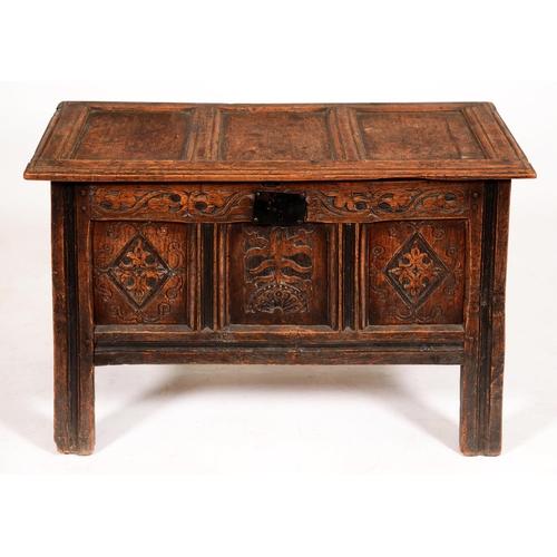 545 - An oak chest, late 17th c, with three panel lid, those to the front carved with lozenges or flower o... 