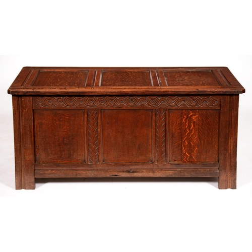 554 - An oak chest, early 20th c, with panelled lid and front, carved frieze and stiles, 59cm h; 51 x 125c... 