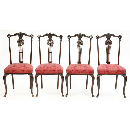 557 - James Shoolbred & Co. A set of four Edwardian carved mahogany salon chairs, the back leg stamped... 