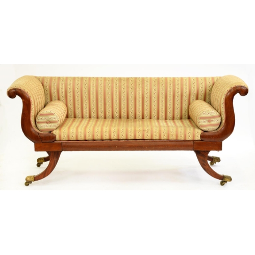 563 - A Victorian mahogany scroll-end sofa, brass paw castors, with matching bolsters, 193cm l... 