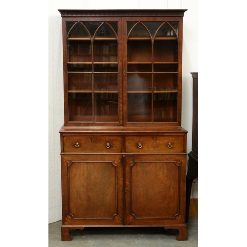 593 - A George III mahogany bookcase-press, with fluted cavetto cornice and fitted with adjustable shelves... 