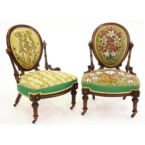 605 - Two similar Victorian walnut nursing chairs, with padded oval back, pottery castors