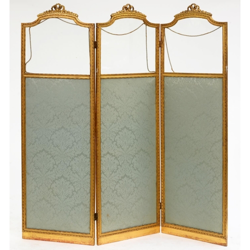 606 - A French giltwood screen, c1900, in Louis XVI style, each of the three leaves with glazed upper part... 