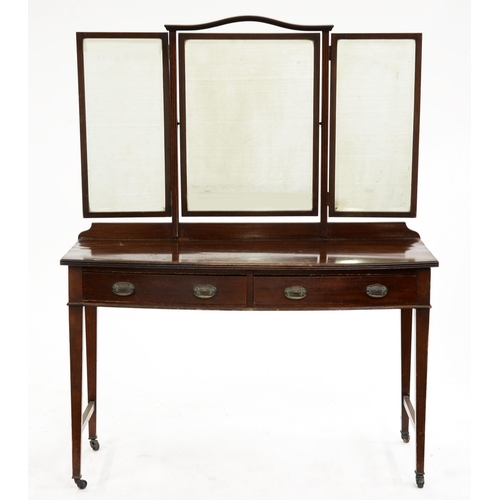 624A - A mahogany bow fronted dressing table, the triple mirror with bevelled plate, on square tapering leg... 