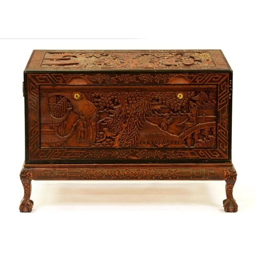 1173 - A Chinese carved camphor wood chest on stand, c1930s, with claw and ball feet, 73cm h; 104 x 52cm... 