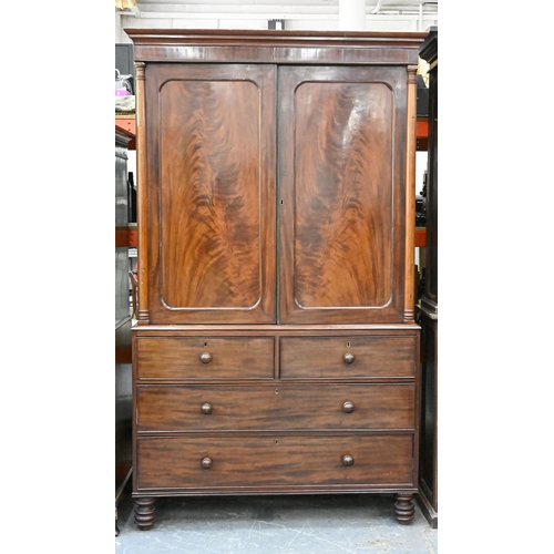 1227 - A Victorian mahogany linen press, the upper part fitted with trays enclosed by a pair of doors with ... 