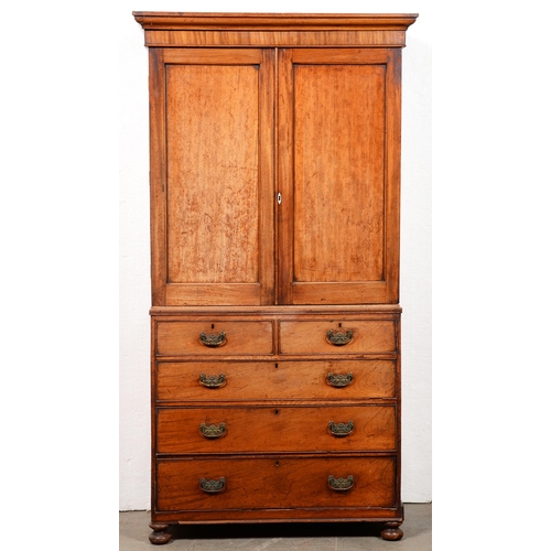 1486 - A George III mahogany linen press, the upper part enclosed by panelled doors, the lower part with tw... 