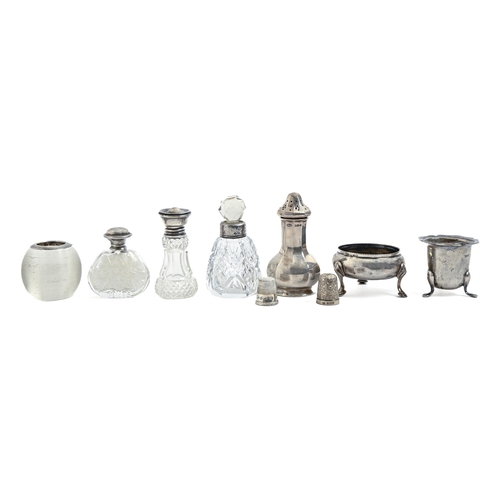 239 - Miscellaneous silver condiments, two thimbles and silver mounted glass scent and other bottles, and ... 