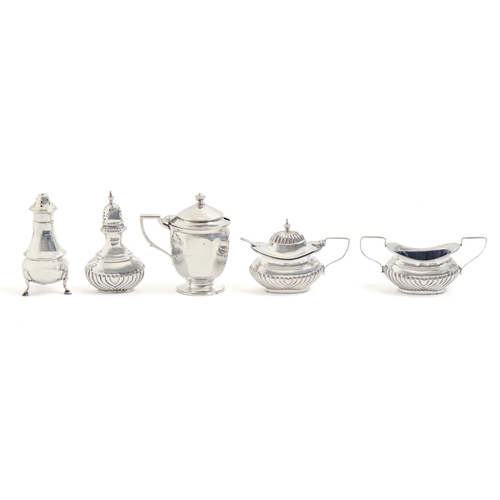 243 - An Edwardian silver condiment set, pepperette 90mm h, by Thomas Henry Blake, Sheffield 1905, a silve... 