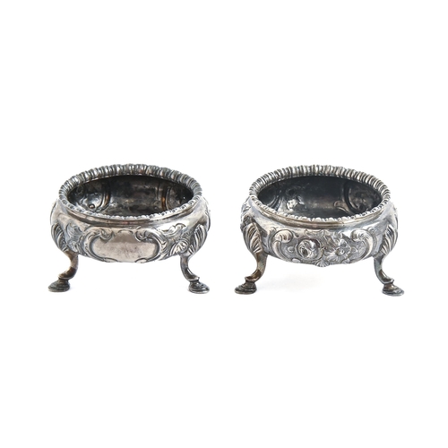 265 - A pair of Victorian silver salt cellars, chased with flowers, on three hoof feet, 70mm diam, by Dani... 