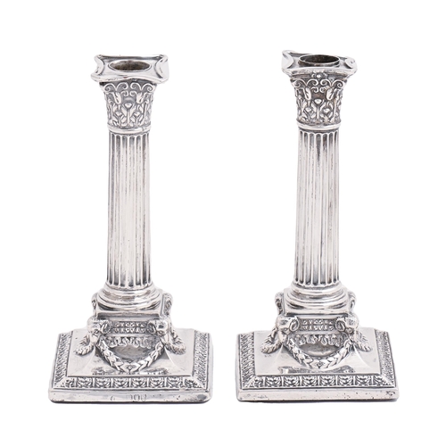 296 - A pair of Victorian silver dwarf columnar candlesticks, 18cm h, by Nathan & Hayes, London 1892, ... 