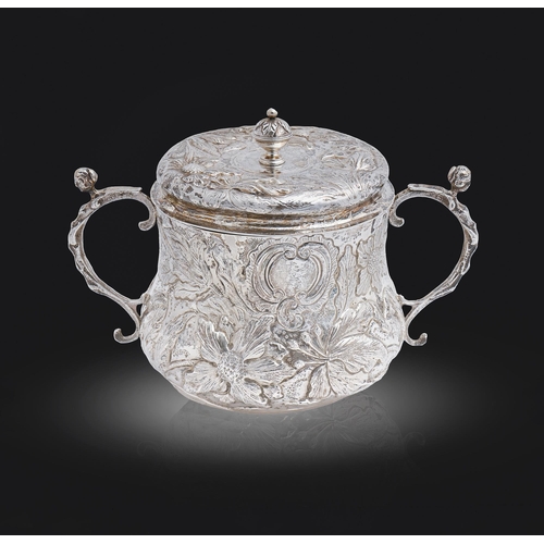 317 - A Charles II silver porringer and cover, decorated in punchwork and chased in high relief with flowe... 
