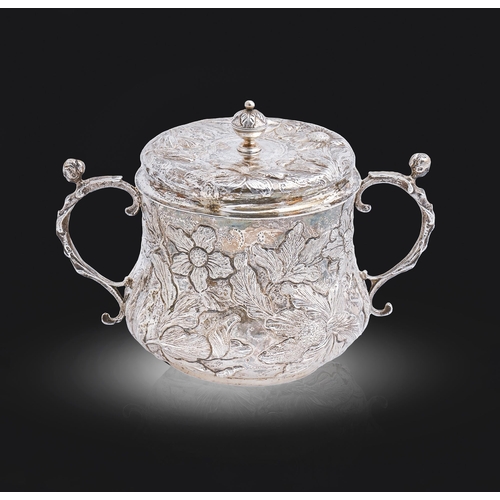 317 - A Charles II silver porringer and cover, decorated in punchwork and chased in high relief with flowe... 