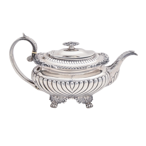 348 - A George IV silver teapot, the gadrooned rim with shells at intervals, crested, handle with ivory in... 