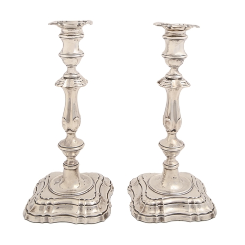 365 - A pair of Edwardian silver candlesticks, in mid 18th c English style, nozzles, crested, 30.5cm h, by... 