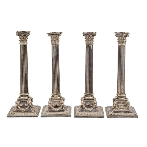 367 - A set of four Victorian EPNS column candlesticks, the square foot embossed with ram's heads and fest... 