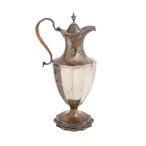 368 - A George III silver lidded jug, of fluted shield shape, the domed lid with urn finial, engraved... 