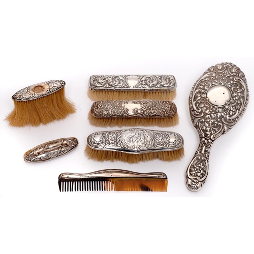 375 - Four silver mounted brushes, a nail buffer, comb and hand mirror, early 20th c, various makers and d... 