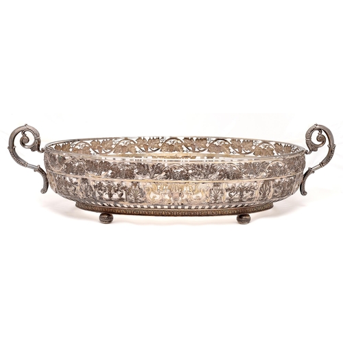 379 - A German silver centrepiece, the two handled oval openwork bowl with grapevine border above panels o... 