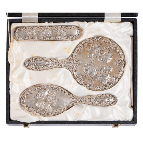 438G - An Elizabeth II four-piece silver brush set, die stamped with cherub's heads, by W I Broadway & ... 