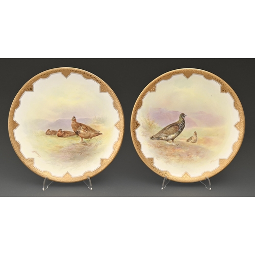 505 - A pair of Royal Doulton bone china dessert places, c1913,  painted by J Hancock, both signed, with g... 