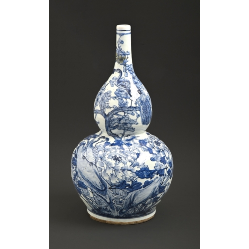 542 - A Chinese blue and white double gourd vase, late 19th / early 20th c, painted with peafowl and flowe... 