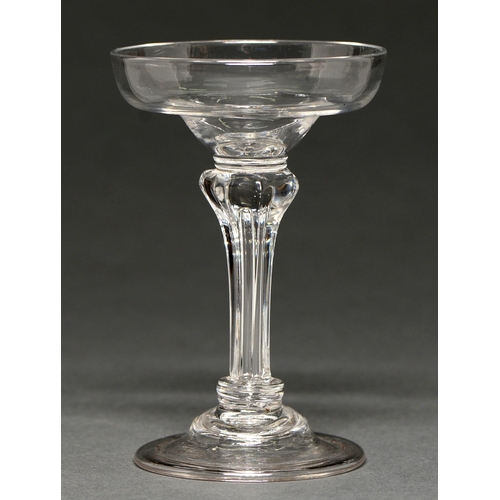 659A - An English champagne or sweetmeat glass, c1750, the ogee bowl on moulded pedestal stem between colla... 