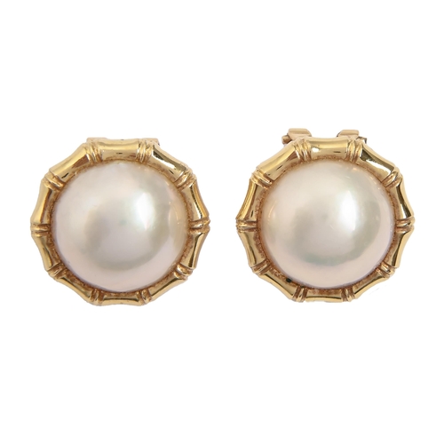 68 - A pair of baroque pearl ear clips, in gold, 16mm diam, marked 18k 750, 7.6g