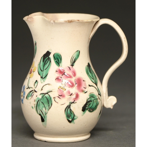 712 - A Staffordshire white glazed stoneware jug, c1760-70,  enamelled with flowers, 80mm h... 