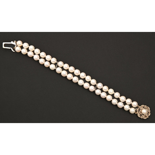 73 - A cultured pearl bracelet, of two rows of approximately 8mm cultured pearls, 9ct gold clasp, 19cm l,... 