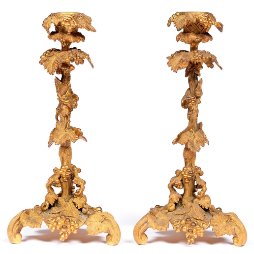 805 - A pair of naturalistic gilt brass candlesticks, late 19th c, in the form of grapevines, 28cm h... 