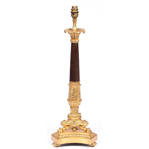 806 - A French ormolu and patinated lamp, 20th c, in Empire style, the acanthus clad pillar on three lion ... 