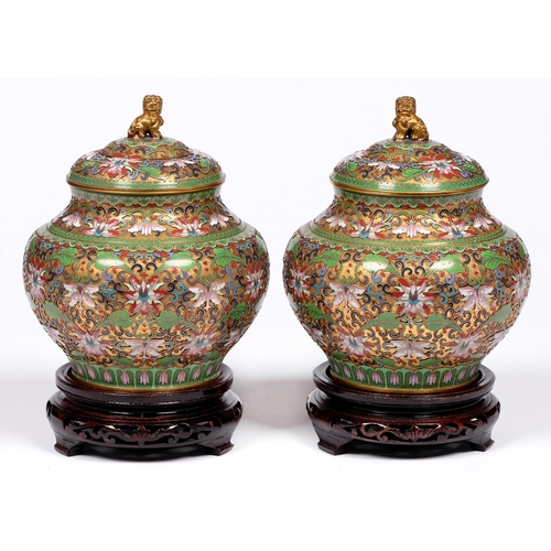 817 - A pair of Chinese cloisonne enamel and gilt brass jars and covers, 20th c, in a predominantly apple ... 