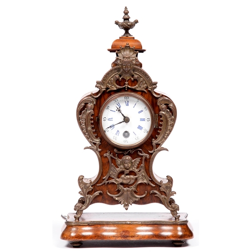 853 - A French walnut mantel clock, late 19th c, in Louis XV style, with brass mounts and enamel dial, on ... 