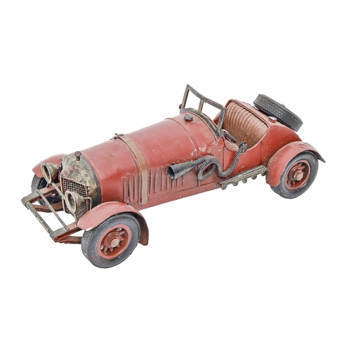 868 - A red painted tinplate model racing car based on a Mercedes Benz, 1920's style, 26.5cm l... 