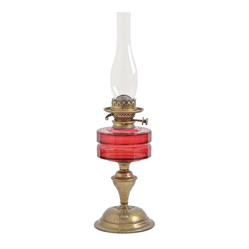 888 - An Art Nouveau brass oil lamp, with faceted cranberry glass fount and Hinks's patent duplex burner, ... 