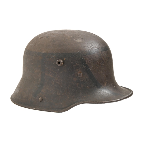 907 - A WWII German steel helmet, traces of black paint, the leather partial lining inscribed on the band ... 